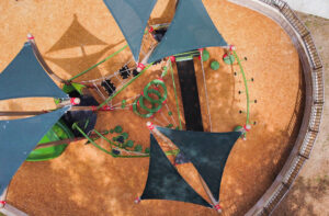 A vibrant, nature-inspired playground featuring Sprig and Tree Tops components.